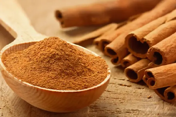 Hechizo para Atraer Dinero 6 Cuchara de madera con polvo de canela y ramitas de canela para un Hechizo para Atraer Dinero.
